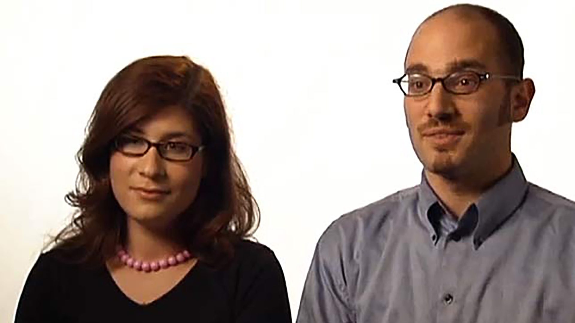 A young adult couple is interviewed against a white background