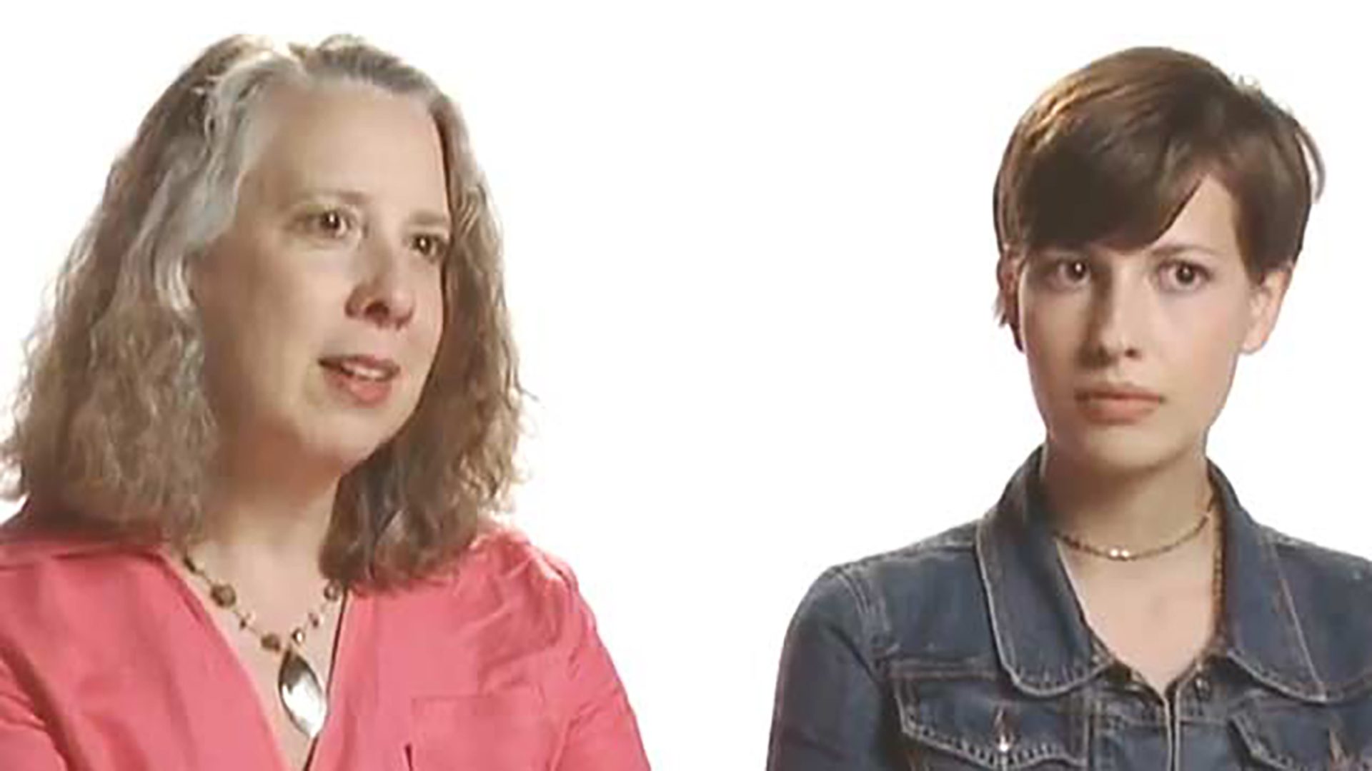 An adult woman wearing pink and a young adult woman with short hair wearing a denim jacket are interviewed together.