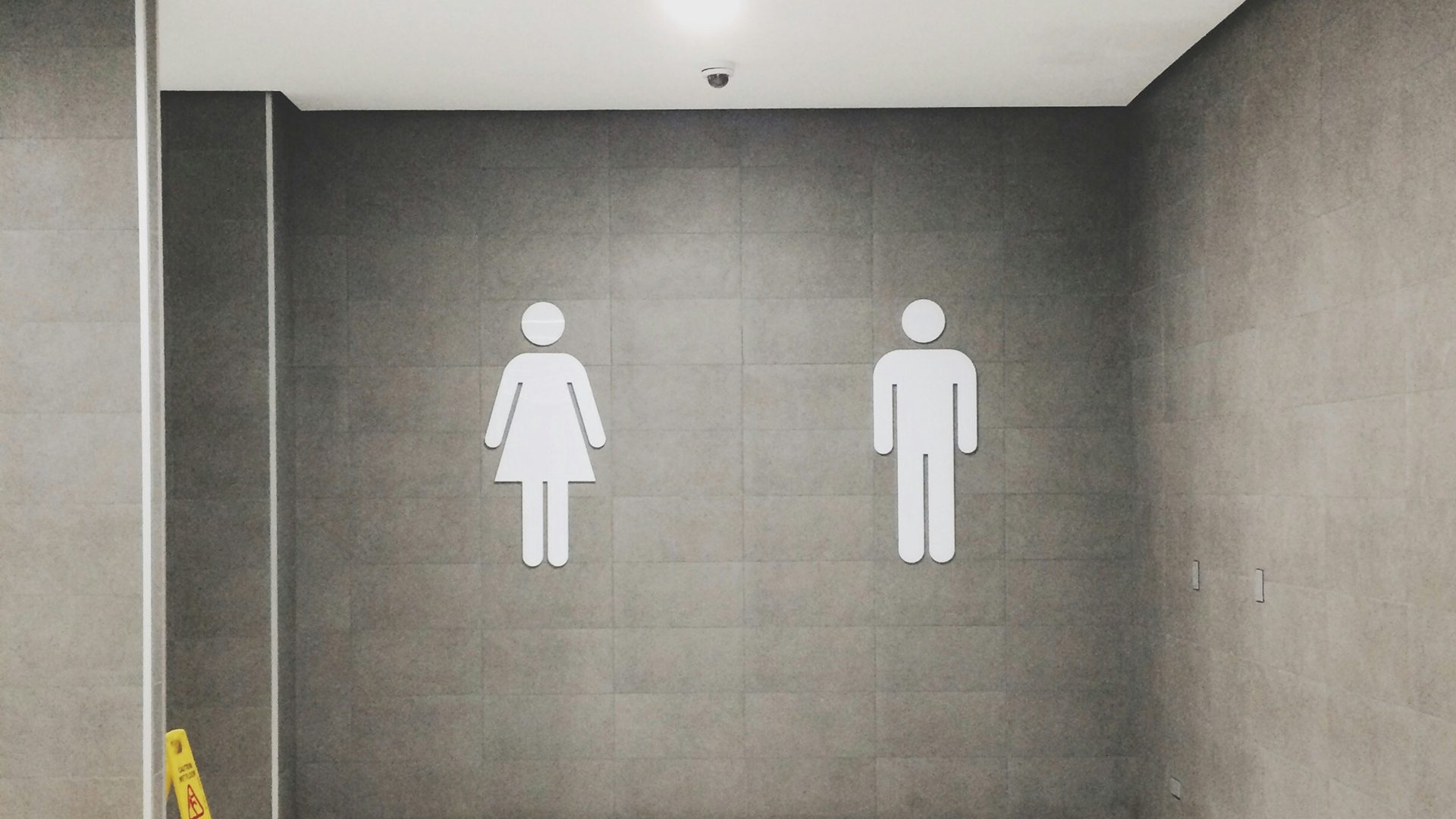 Signage indicating women's and men's restrooms