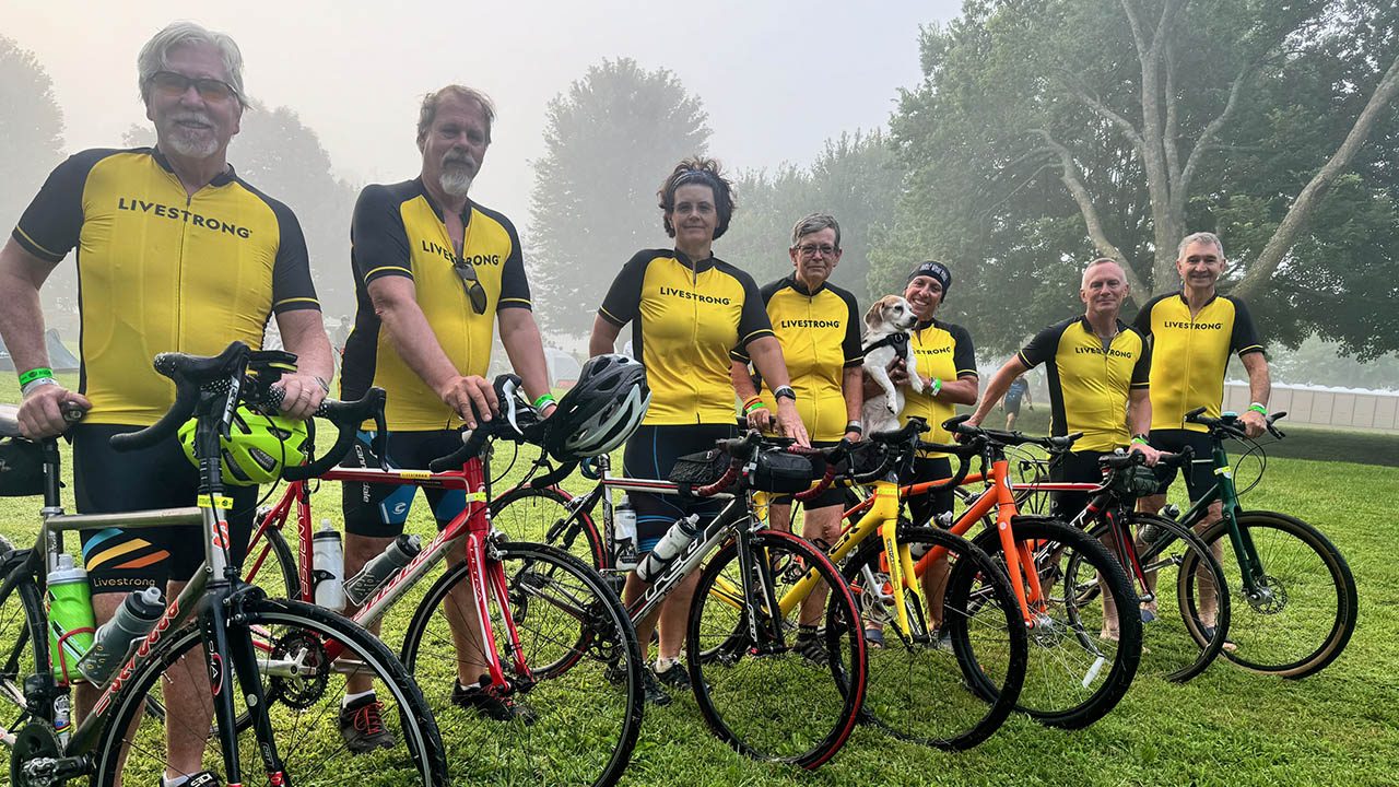 A group of cyclists wearing yellow jerseys