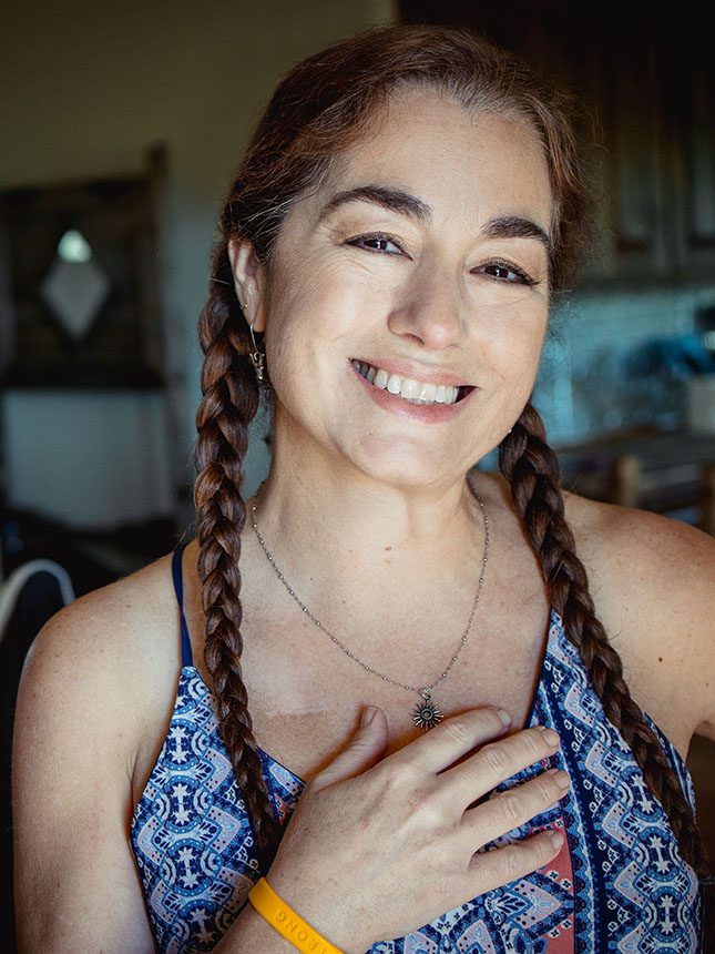 A smiling woman with braids