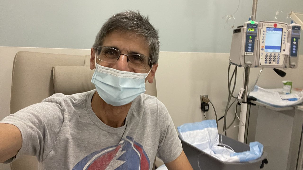 A man wearing a surgical mask receiving treatment in a hospital