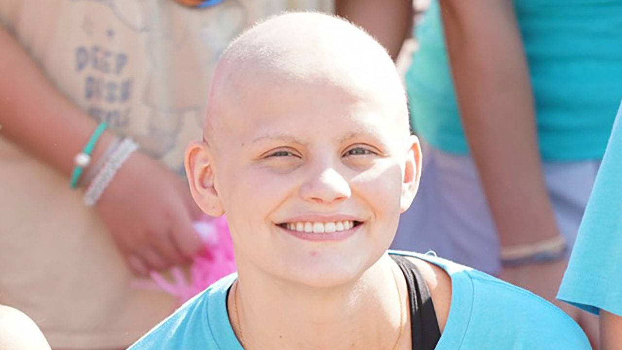 A smiling teen cancer patient