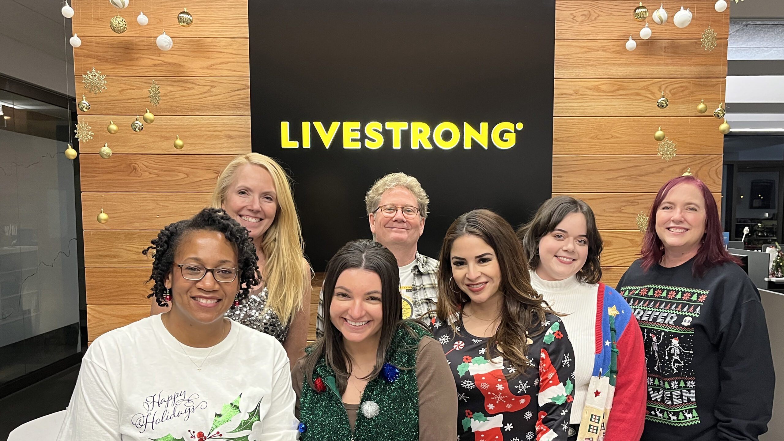 A group of people in front of a Livestrong sign