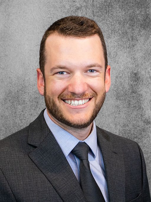 A professional headshot of an adult man