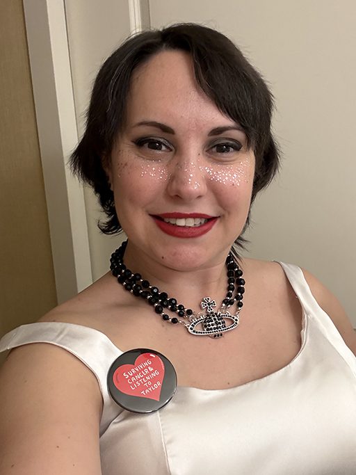 A selfie of an adult woman in a white shirt