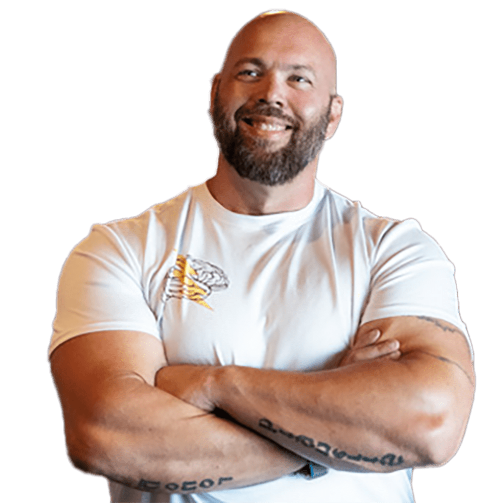An adult man in a white shirt crossing his arms