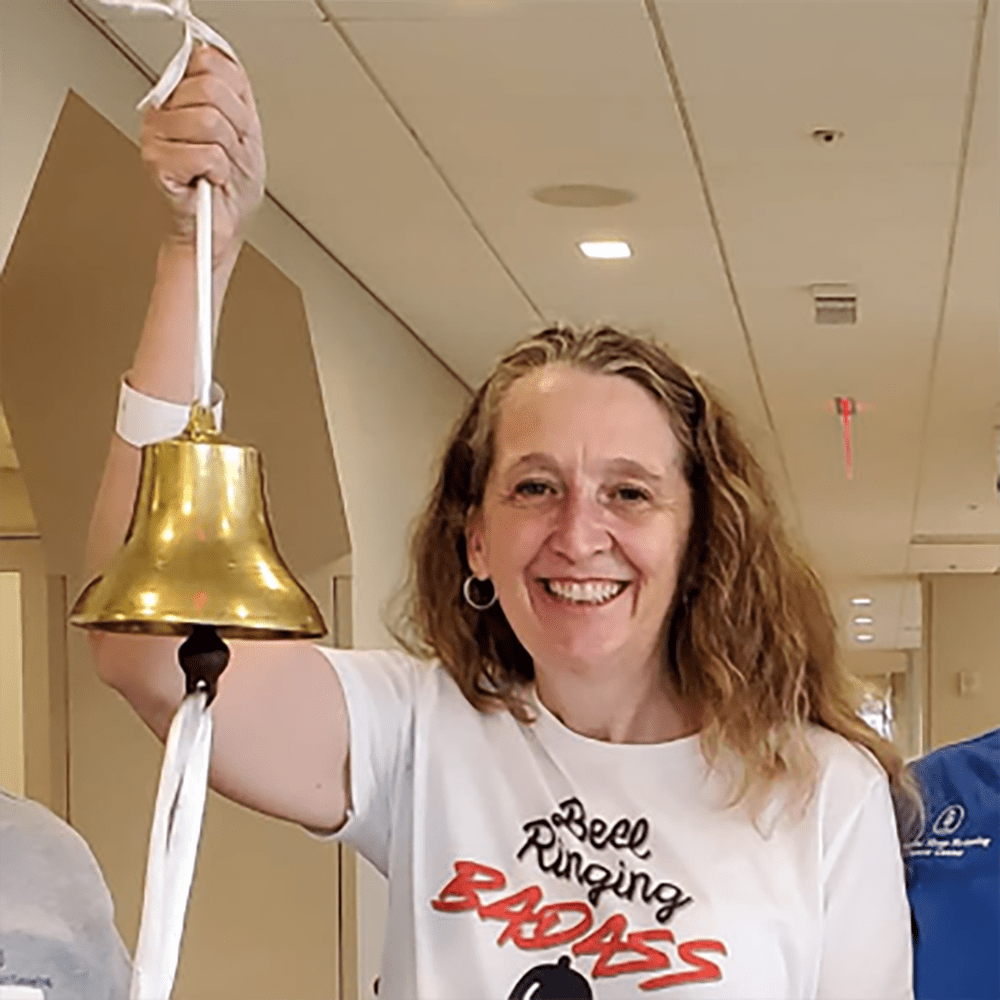 An adult woman ringing a bell