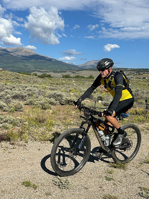 Man riding mountain bike through Leadville Colorado during the Leadville Trail 100 MTB