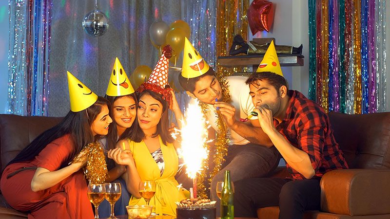 Group of friends celebrating over a cake