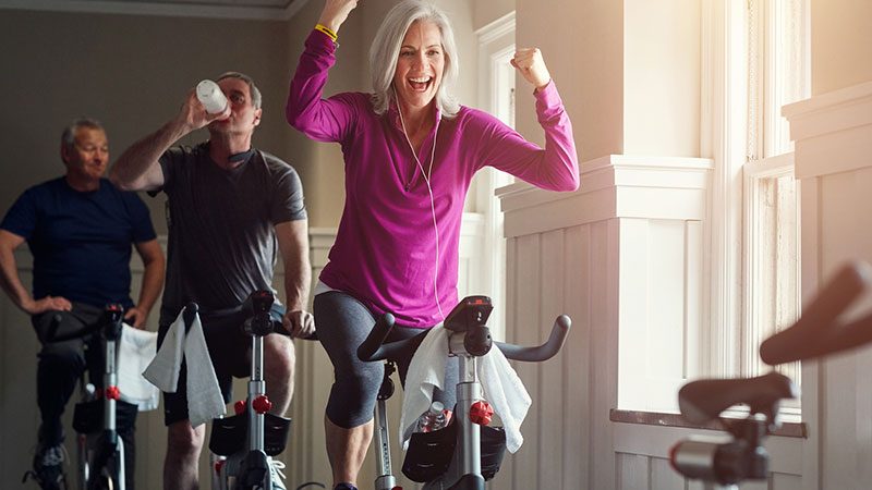 Woman celebrating finishing a spin class