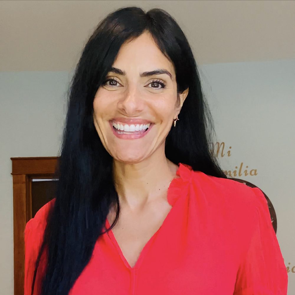 A smiling woman in a red shirt