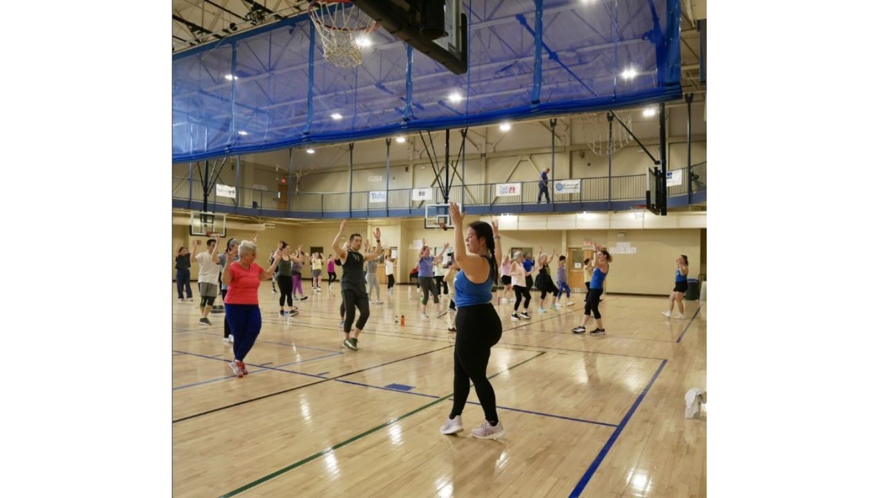 Zumbathon participants dancing in a gym