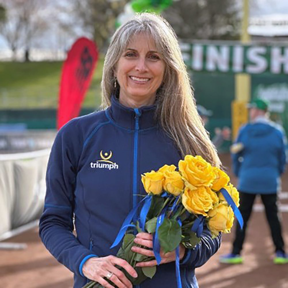 A woman holding a bouquet of yellow roses
