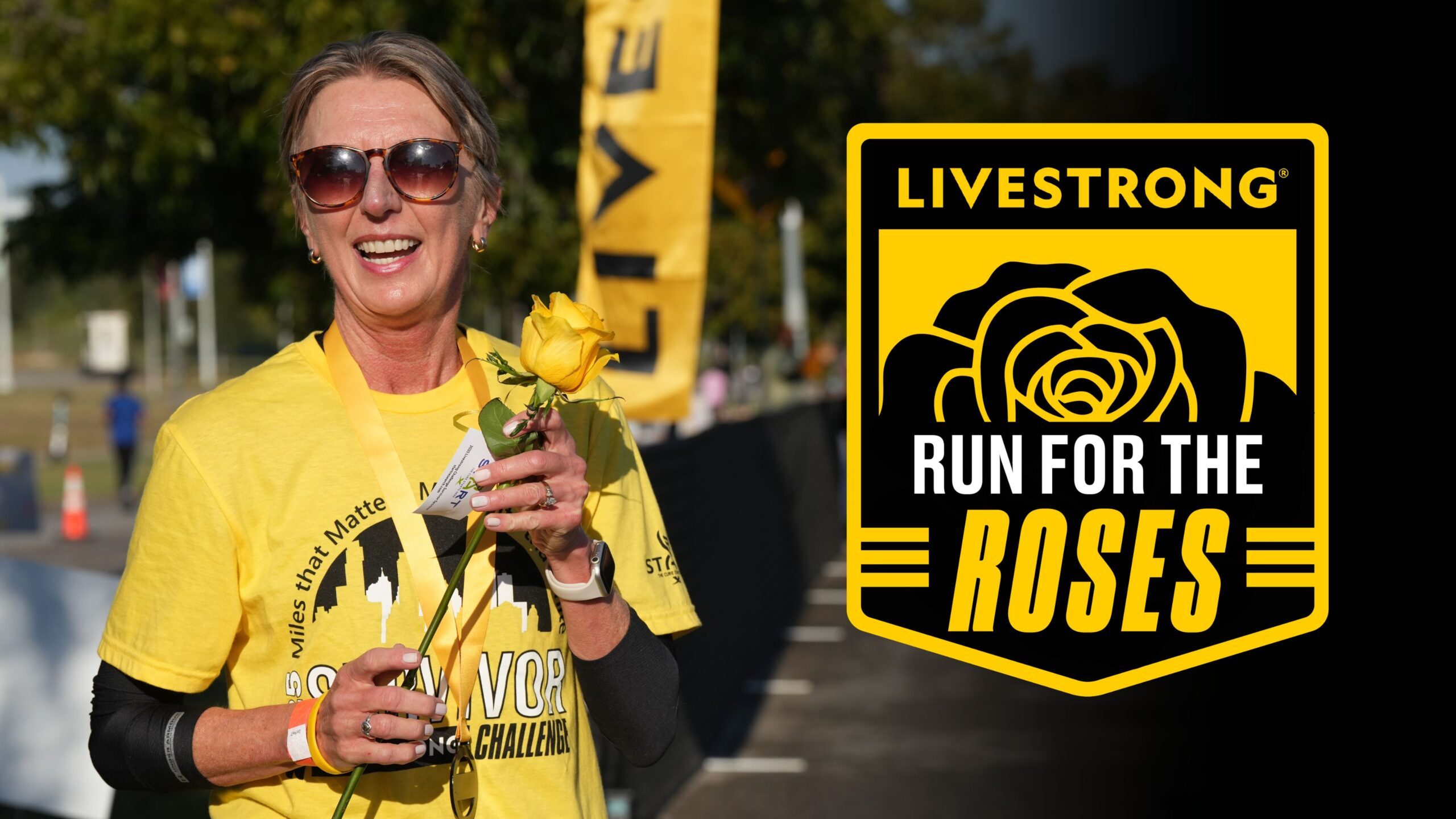 Smiling woman holding a yellow rose