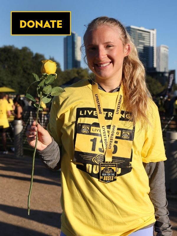 Young woman wearing medal holding yellow rose after a run